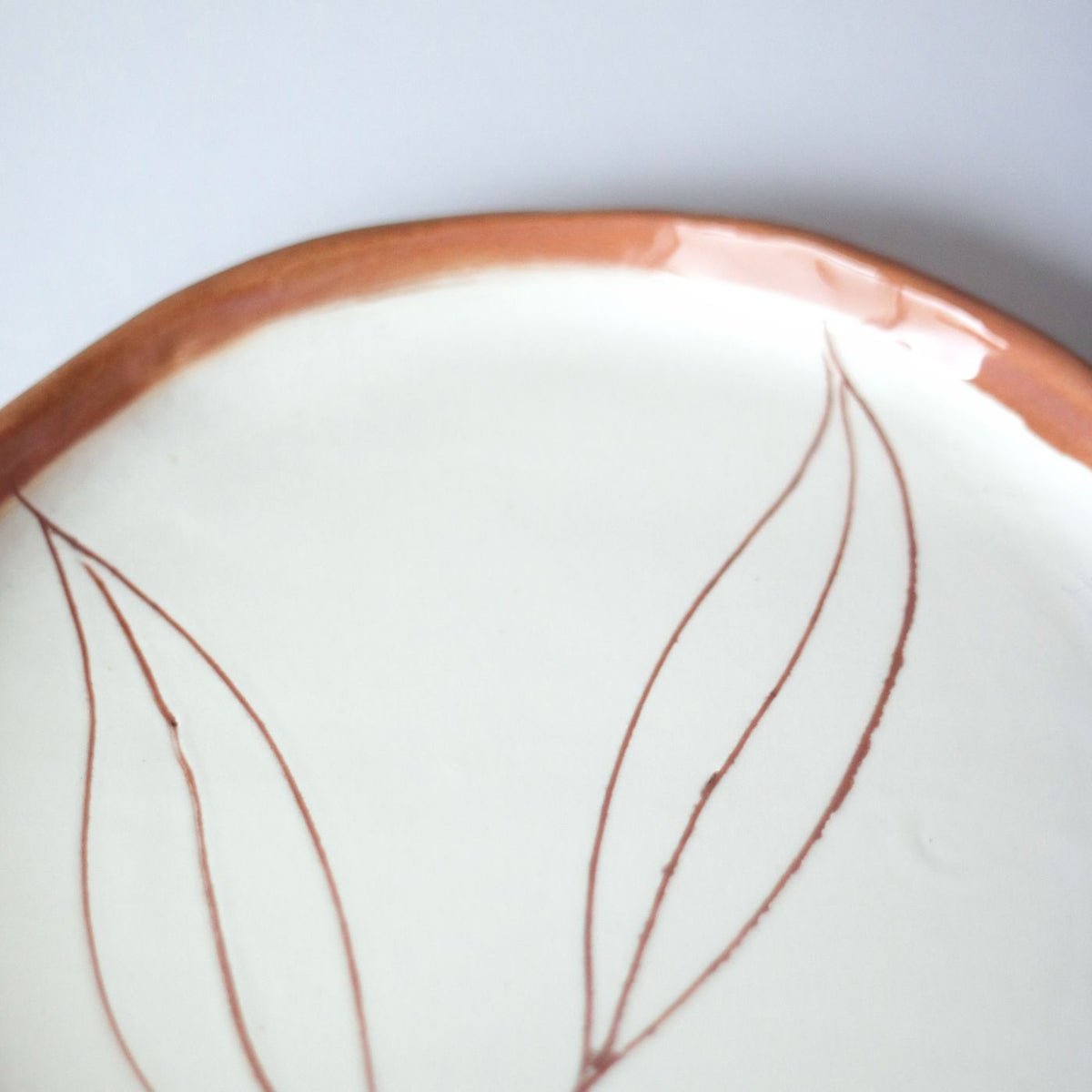 A decorated porcelain plate, photographed plainly so the surface reads clearly.